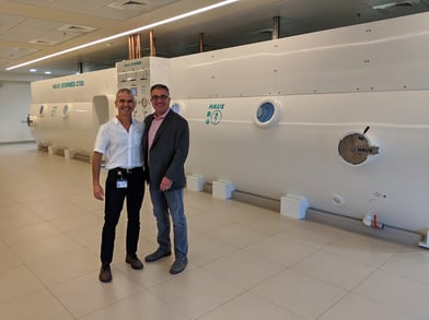 Alan A. Katz, MD and professor Shai Efrati in Israel infront of Efrati's multi-place hyperbaric chamber.