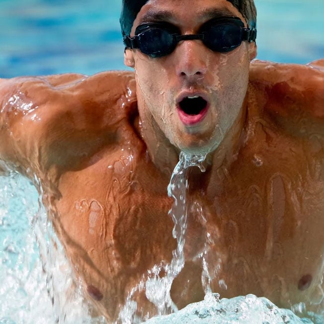 Professional-man-swimming-with-hat-and-goggles-at-the-pool-sq