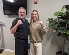 Dr. Katz posing with patient fighter, holding up fists