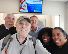 HMS staff posing with older patient with smiles