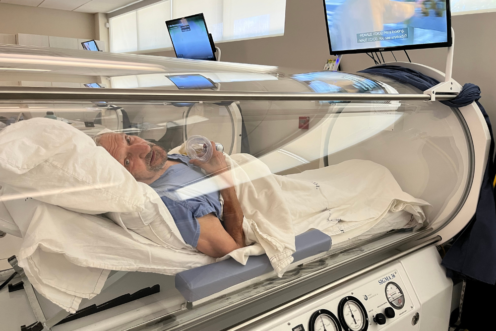 Man inside Hyperbaric Oxygen therapy chamber at safe clinic Man inside Hyperbaric Oxygen therapy chamber at safe clinic