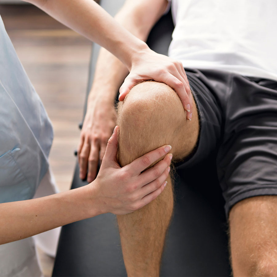 Patient at the physiotherapy doing physical exercises with his therapist