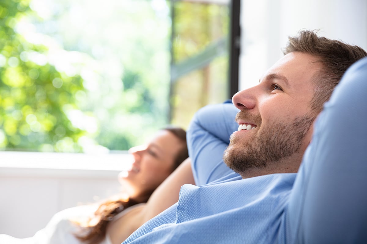 man and woman sitting back and relaxing