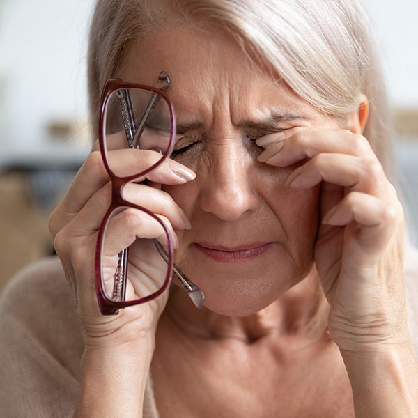 close up of woman massaging close to her eyes