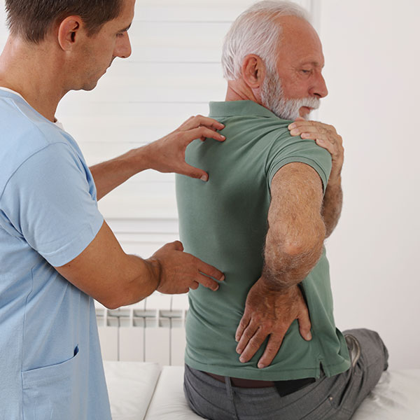 doctor examining patient with spine injury