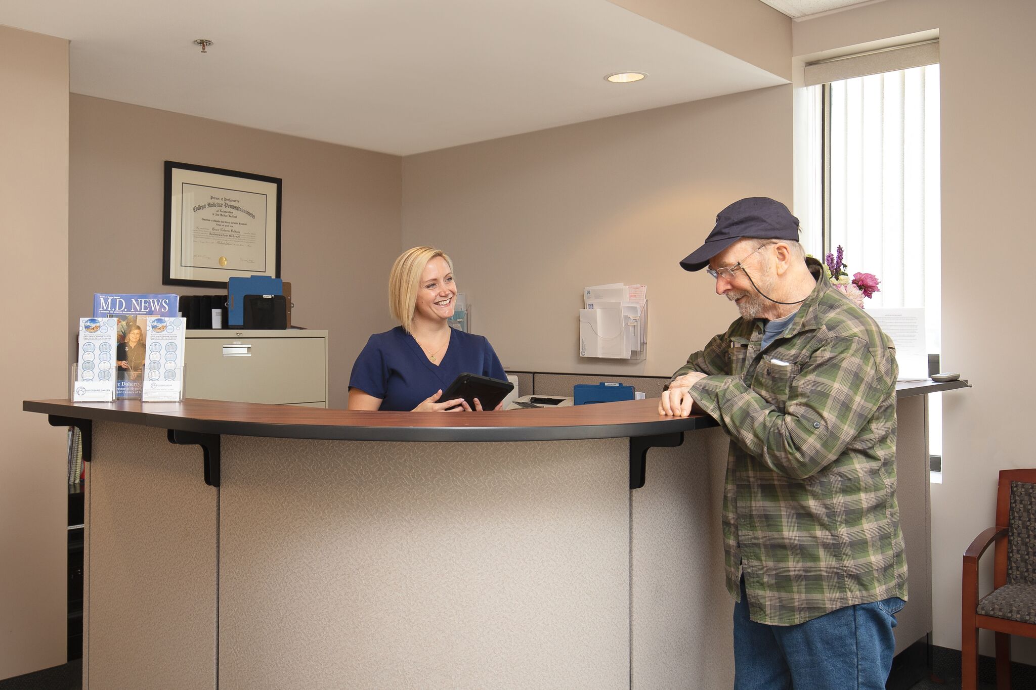 nurse assisting patient at front desk of hyperbaric office