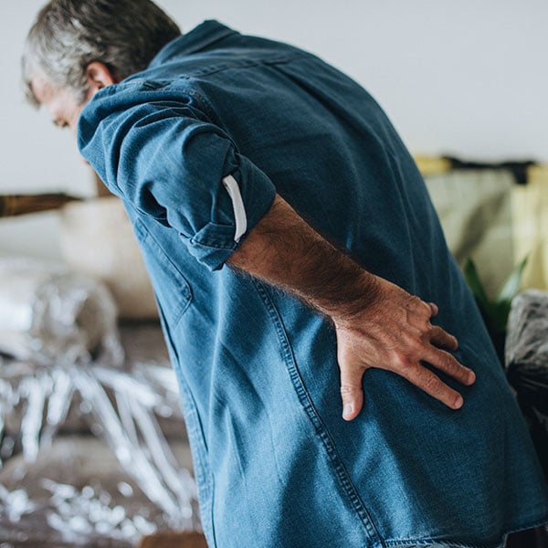 man holding back in pain man holding back in pain