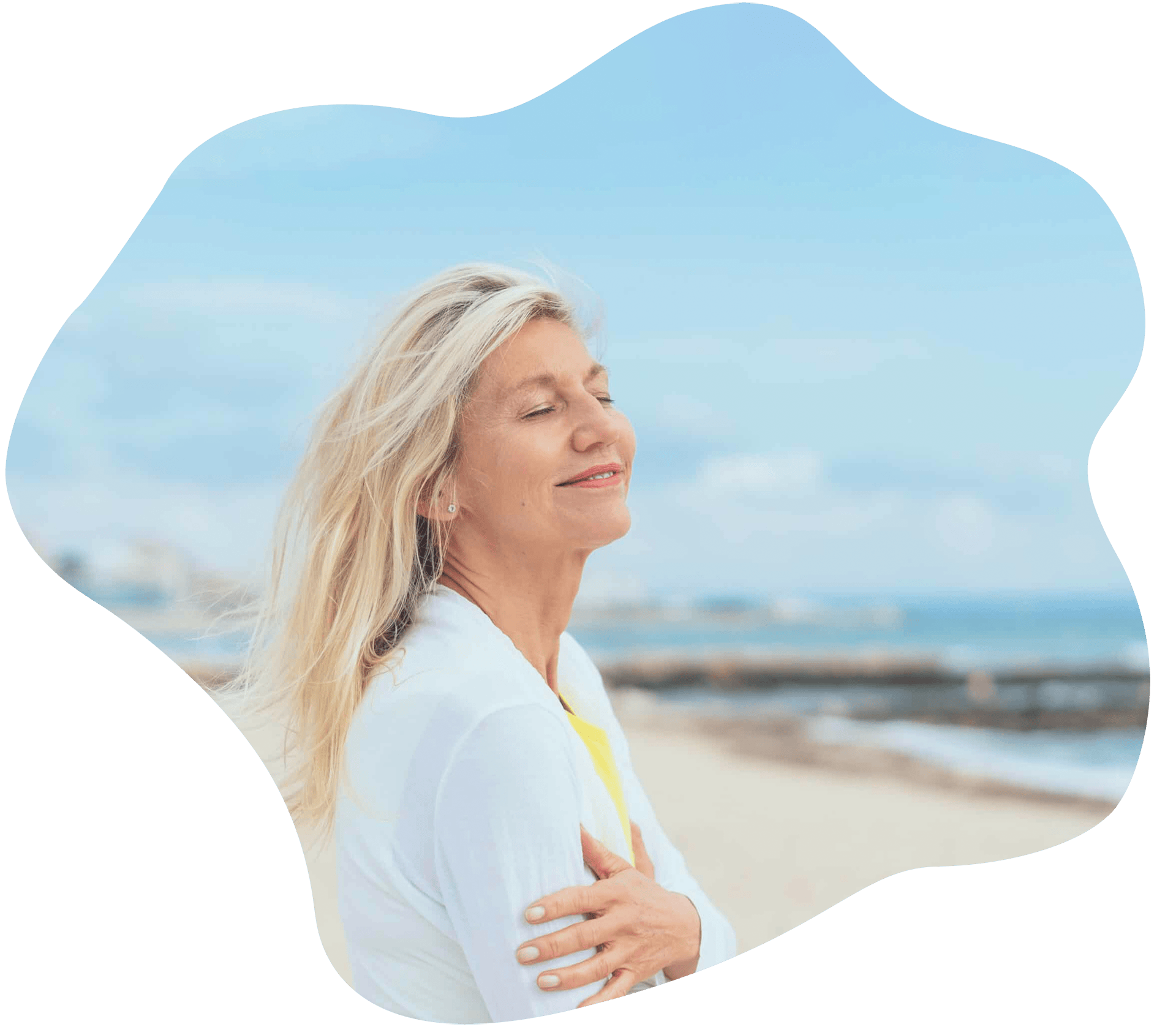 woman taking in a deep breath at a beach